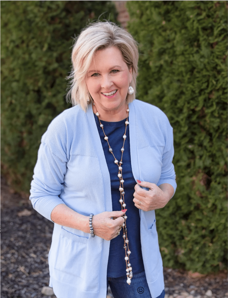 Tania Stephens is a light blue sweater and pearls
